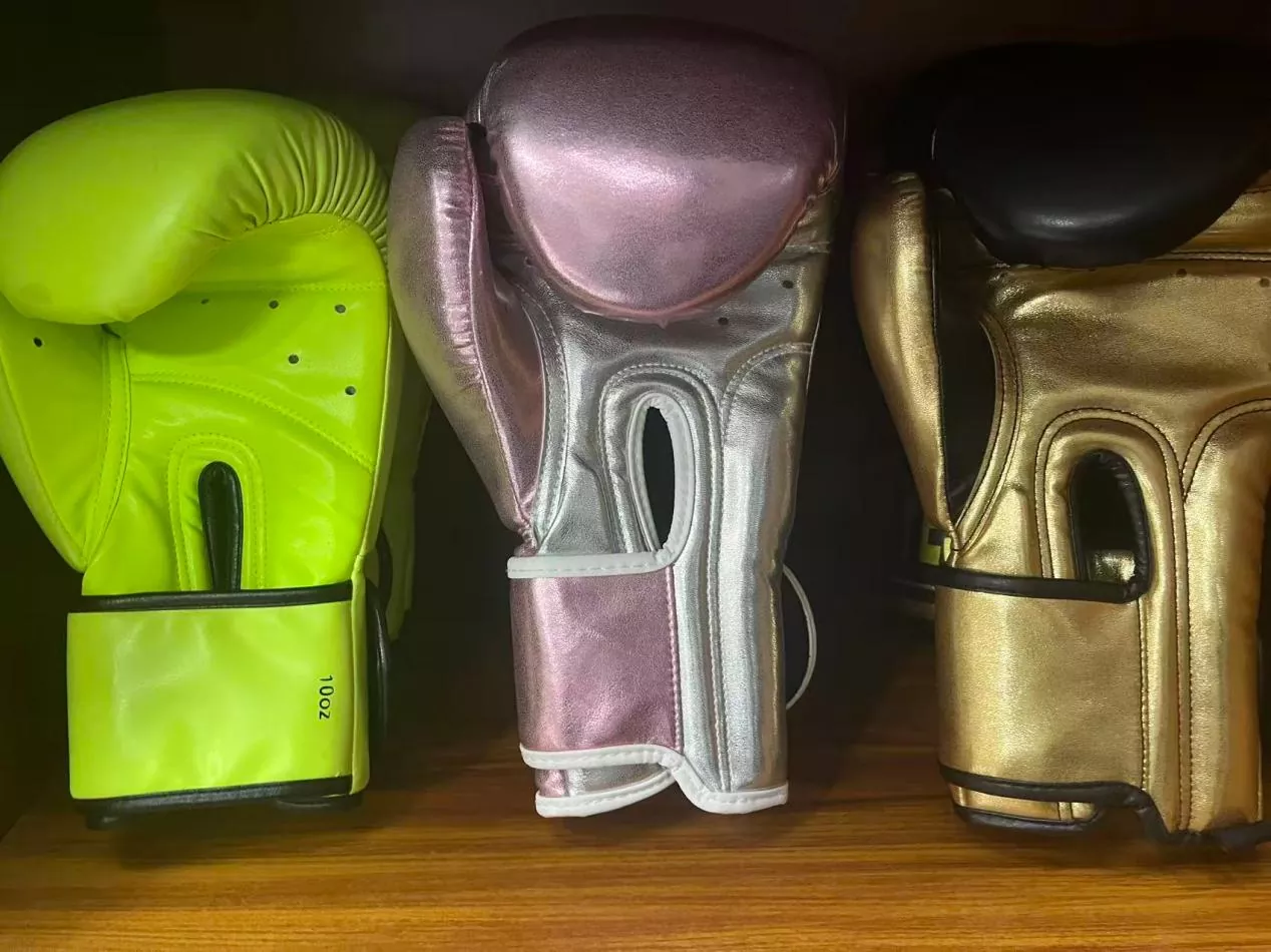 Traditional boxing gloves with closed-finger design and thick foam padding